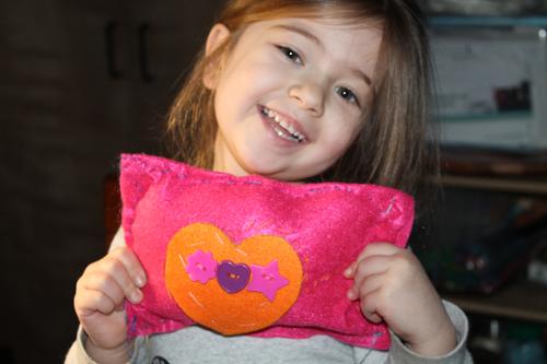 Sewing a pillow with felt and buttons